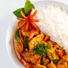 Curry dish with rice on a white plate